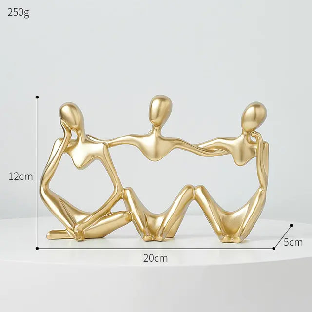 Three Nordic style decorative art figurines, holding each other while sitting.  Gold colored - Epiceasyshop1