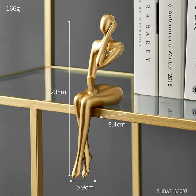 Nordic style decorative art figurines. Gold colored, sitting with one hand on the ear- Epiceasyshop1