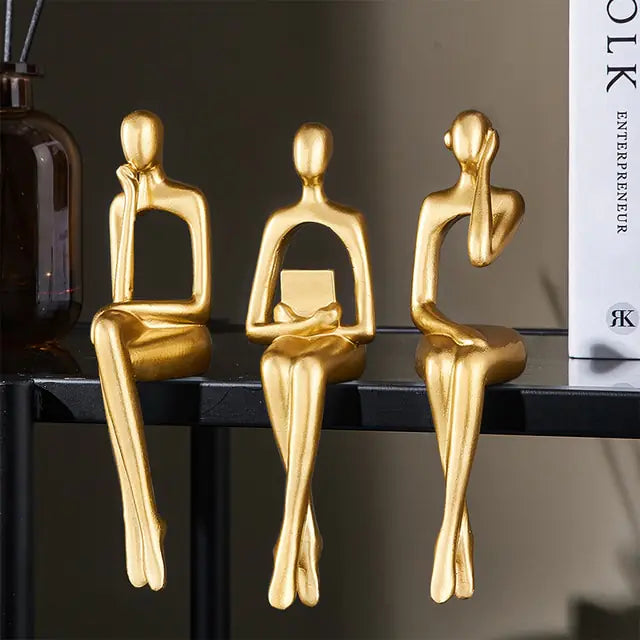 Three Nordic style decorative art figurines. Gold colored, sitting next to each other- Epiceasyshop1