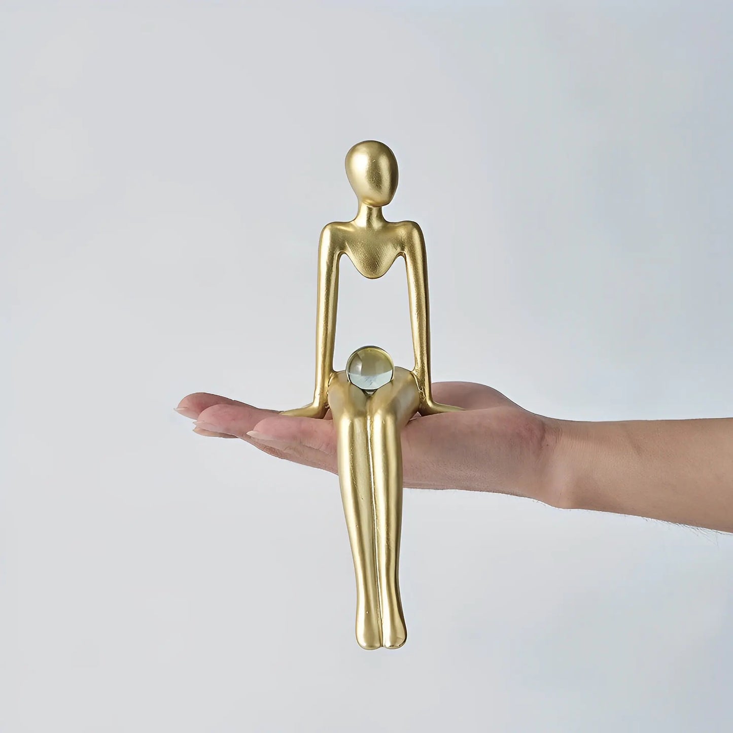 Nordic style decorative art figurines. Gold colored, sitting on a human hand to show the size- Epiceasyshop1